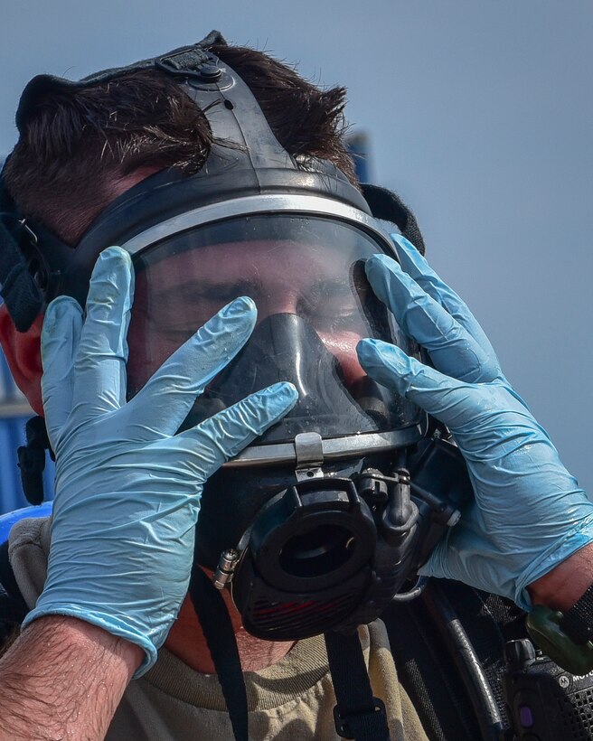 U.S. Army Reserve Sgt. Landon P. Jezek, with the 329th Chemical Company based in Orlando, Fla., removes his self-contained breathing apparatus (SCBA) after conducting a joint hazard material exercise with the U.S. Army and the Miami-Dade Fire Rescue Department at the Port of Miami, Feb. 18, 2017.  The 329th Chemical, Biological, Radiological, and Nuclear (CBRN) Company (Reconnaissance and Surveillance), from Orlando, Fla., the Army Reserve’s 469th Ground Ambulance Company, from Wichita, Kan., and the Florida National Guard’s Civil Support Team, spent the day training with MDFR firefighters during a sustainment training exercise that combines civil authorities and Defense CBRN Response Force, in Miami, Florida. (U.S. Army Reserve photo by Master Sgt. Marisol Walker/Released)