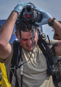 U.S. Army Reserve Sgt. Landon P. Jezek, with the 329th Chemical Company based in Orlando, Fla., removes his self-contained breathing apparatus (SCBA) after conducting a joint hazard material exercise with the U.S. Army and the Miami-Dade Fire Rescue Department at the Port of Miami, Feb. 18, 2017.  The 329th Chemical, Biological, Radiological, and Nuclear (CBRN) Company (Reconnaissance and Surveillance), from Orlando, Fla., the Army Reserve’s 469th Ground Ambulance Company, from Wichita, Kan., and the Florida National Guard’s Civil Support Team, spent the day training with MDFR firefighters during a sustainment training exercise that combines civil authorities and Defense CBRN Response Force, in Miami, Florida. (U.S. Army Reserve photo by Master Sgt. Marisol Walker/Released)