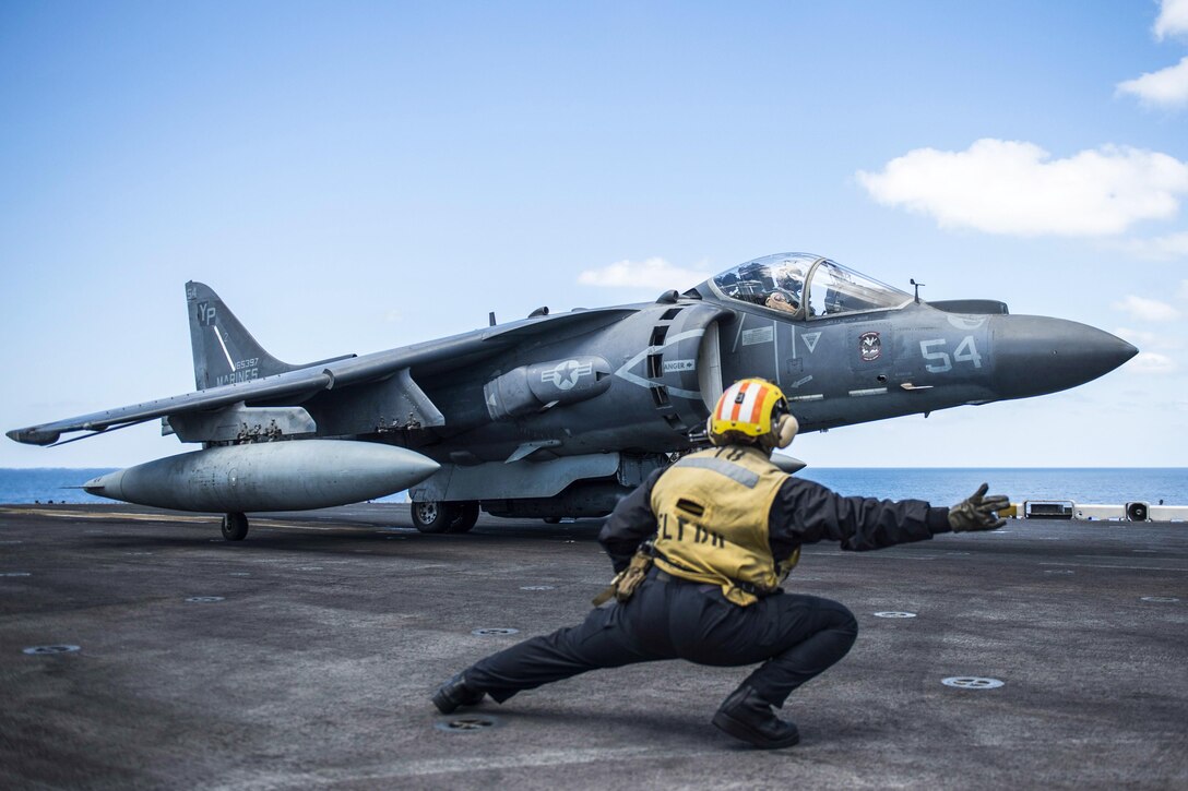 Navy Petty Officer Morgan Jackson signals to an AV-8B Harrier to launch on the flight deck of the USS Makin near the Persian Gulf, Feb. 10, 2017.  Navy photo by Petty Officer 3rd Class Devin M. Langer