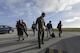 U.S. Air Force Capt. Brian Navin, 909th Air Refueling Squadron pilot, guides reporters toward an aircraft Feb. 21, 2017, at Andersen Air Force Base, Guam. Media teams visited Andersen to observe Cope North, an annual exercise designed to increase interoperability between the U.S., Japan and Australian air forces. The 909th ARS provided a flight for the visitors aboard a KC-135 Stratotanker for an observation of air-refueling operations. (U.S. Air Force photo by Senior Airman John Linzmeier/released)