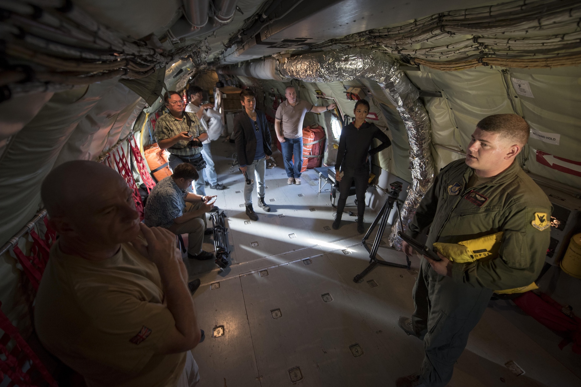U.S. Air Force Staff Sgt. Michael Voorhees, 909th Air Refueling Squadron instructor boom operator, provides a safety brief to local and foreign reporters aboard a KC-135 Stratotanker Feb. 21, 2017, at Andersen Air Force Base, Guam. Reporters flew with the 909th ARS to observe air refueling operations during trilateral exercise Cope North. The exercise is held annually to improve combat readiness, develop synergistic humanitarian assistance, disaster relief operations, and increase interoperability between the U.S., Royal Australian Air Force and Japan Air Self-Defense Force. (U.S. Air Force photo by Senior Airman John Linzmeier/released)
