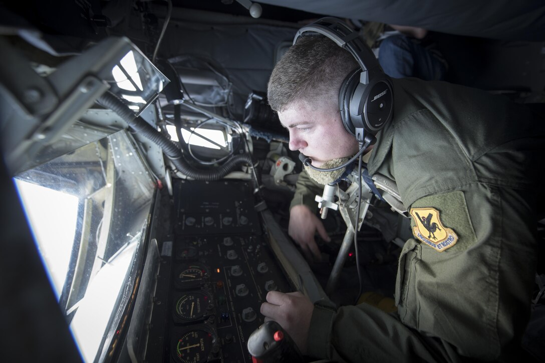 U.S. Air Force Staff Sgt. Michael Voorhees, 909th Air Refueling Squadron instructor boom operator, prepares to conduct in-flight refueling aboard a KC-135 Stratotanker Feb, 21, 2017, off the coast of Guam. Twenty-two flying units, including the 909th ARS, are on Andersen Air Force Base to participate in annual exercise Cope North. Boom operators have the ability to pump thousands of pounds of fuel to any capable aircraft while thousands of feet above the ground. (U.S. Air Force photo by Senior Airman John Linzmeier/released)
