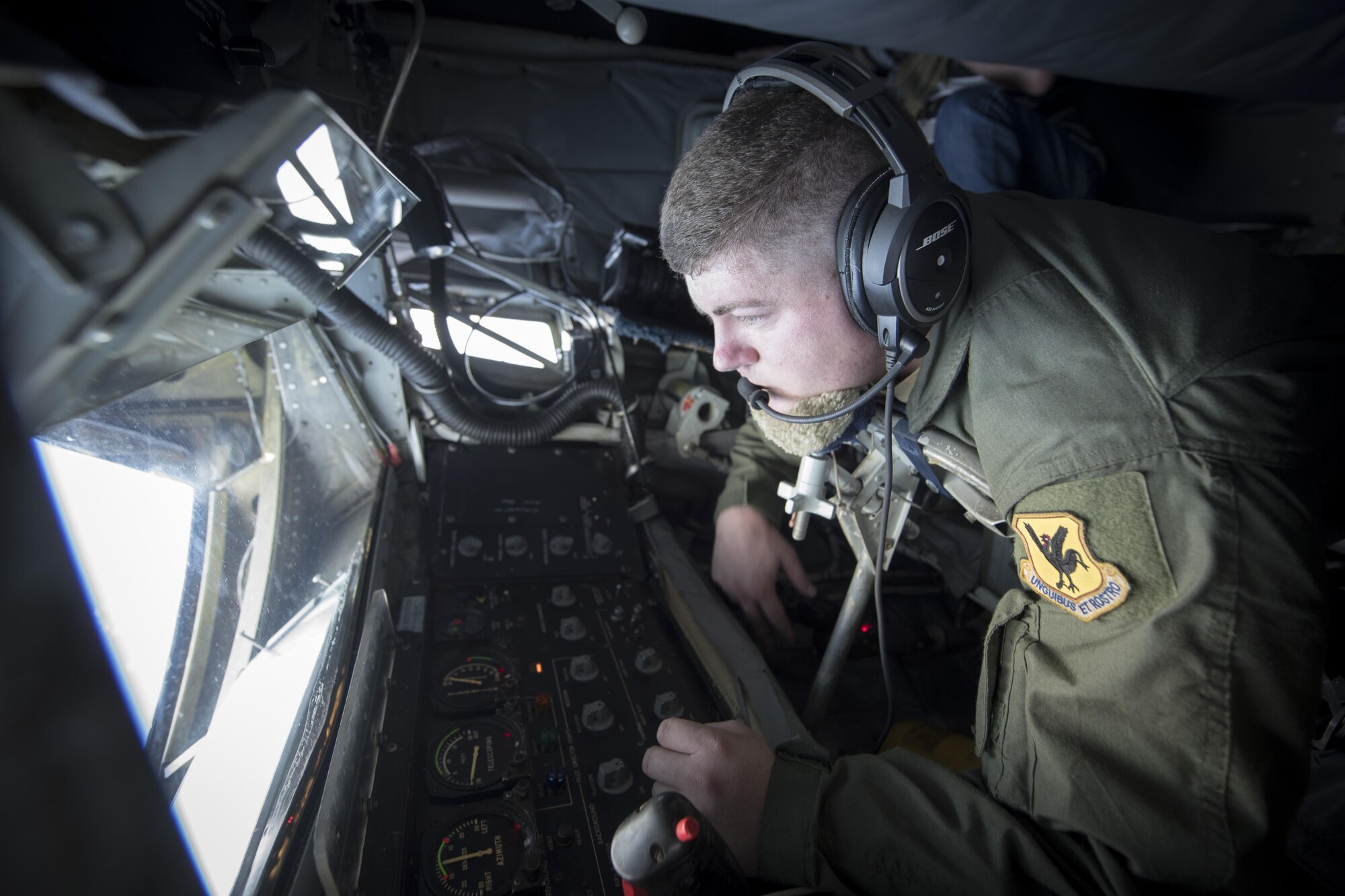 U.S. Air Force Staff Sgt. Michael Voorhees, 909th Air Refueling Squadron instructor boom operator, prepares to conduct in-flight refueling aboard a KC-135 Stratotanker Feb, 21, 2017, off the coast of Guam. Twenty-two flying units, including the 909th ARS, are on Andersen Air Force Base to participate in annual exercise Cope North. Boom operators have the ability to pump thousands of pounds of fuel to any capable aircraft while thousands of feet above the ground. (U.S. Air Force photo by Senior Airman John Linzmeier/released)