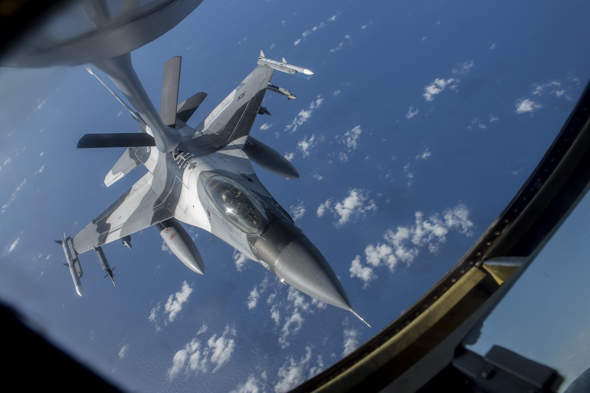 A U.S. Air Force F-16 Fighting Falcon, assigned to the 18th Aggressor Squadron, receives fuel from a 909th Air Refueling Squadron KC-135 Stratotanker Feb. 21, 2017 off the coast of Guam. Both aircraft units are training among Japan Air Self-Defense Force, Royal Australian Air Force and other U.S. Pacific Command units to participate in exercise Cope North. The 909th ARS is located at Kadena Air Base, Japan, and has 15 Stratotankers that deploy to worldwide destinations, providing global reach for U.S. and allied aircraft. (U.S. Air Force photo by Senior Airman John Linzmeier/released)