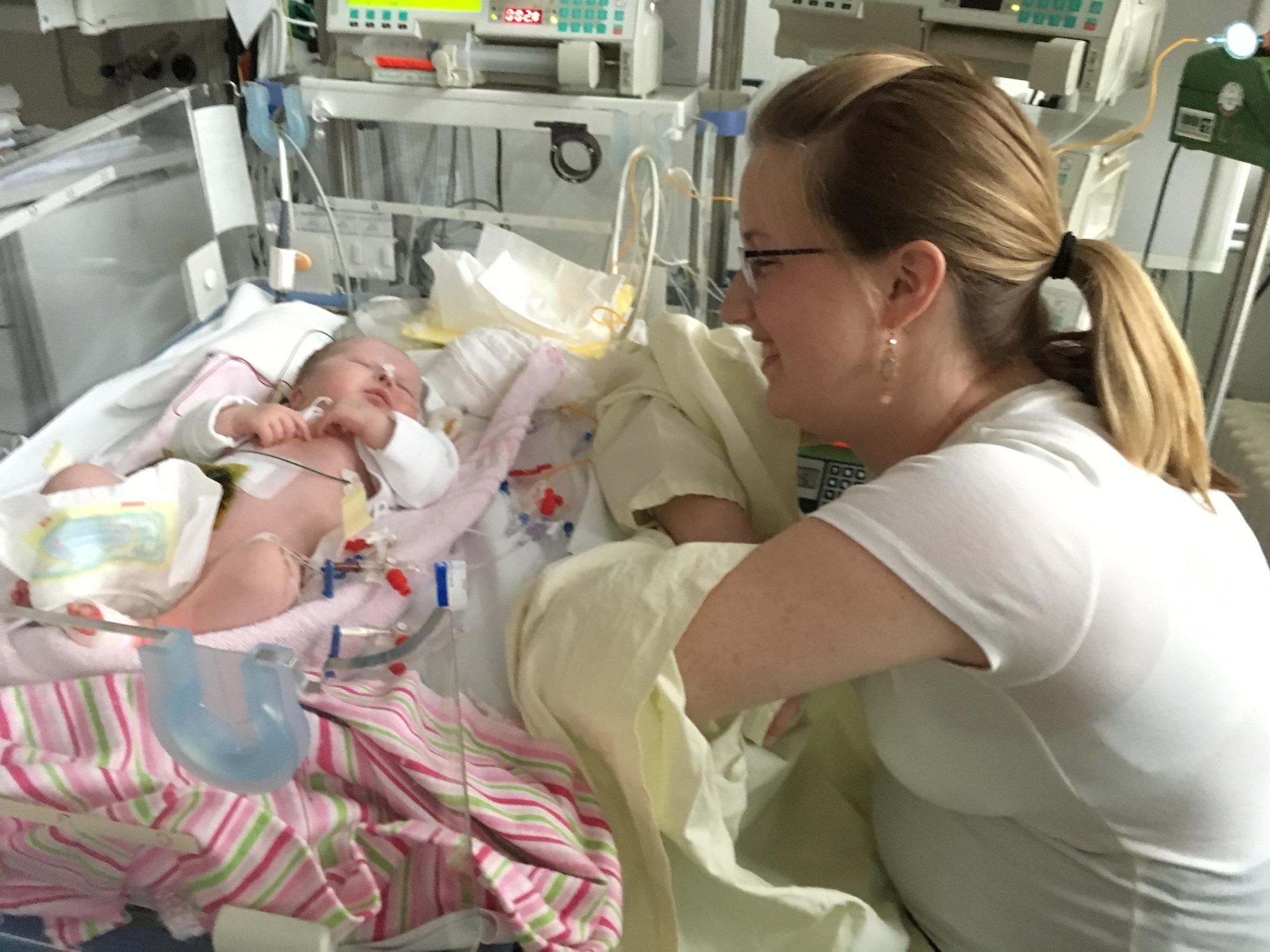 Caitlyn Bass, wife of Senior Airman Jonathan Bass, 86th Airlift Wing photojournalist, smiles at her daughter, Alice Jane Bass, at Westpfalz-Klinikum, Kaiserslautern, Germany, Jan. 24, 2017. Alice spent the first three weeks of her life in the hospital after abdominal surgery. (Courtesy photo by Senior Airman Jonathan Bass)