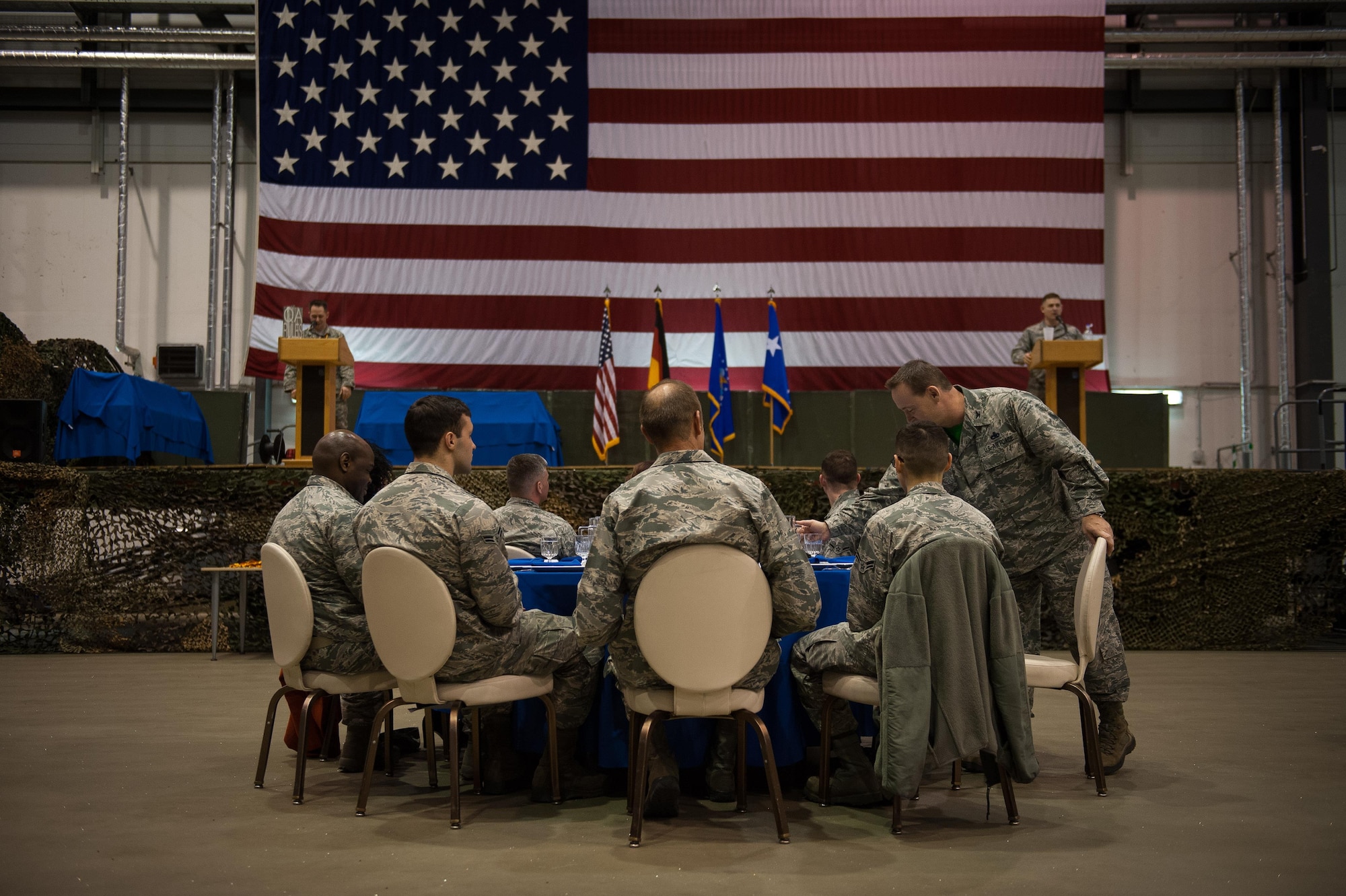 Airmen sit down at a table around Lt. Gen. John B. Cooper, headquarters U.S. Air Force deputy chief of staff for logistics, engineering and force protection, during the 2016 Maintenance and Logistics Airmen Annual Award Ceremony on Ramstein Air Base, Germany, Feb. 17, 2017. Cooper joined Airmen who received annual awards on stage to reward them for their hard work throughout 2016. (U.S. Air Force photo by Senior Airman Lane T. Plummer)