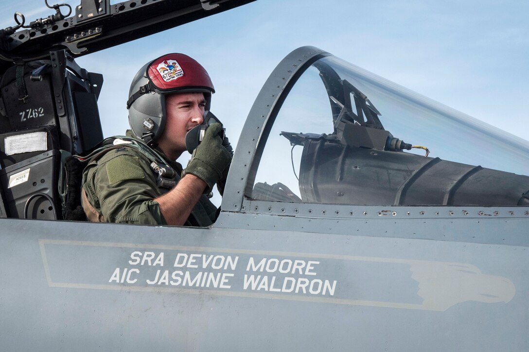 Air Force Capt. Lance Coldren secures his oxygen mask in the cockpit of his F-15 Eagle aircraft before takeoff during exercise Cope North at Andersen Air Force Base, Guam, Feb. 20, 2017. Coldren is a pilot assigned to the 67th Fighter Squadron. Air Force photo by Senior Airman John Linzmeier