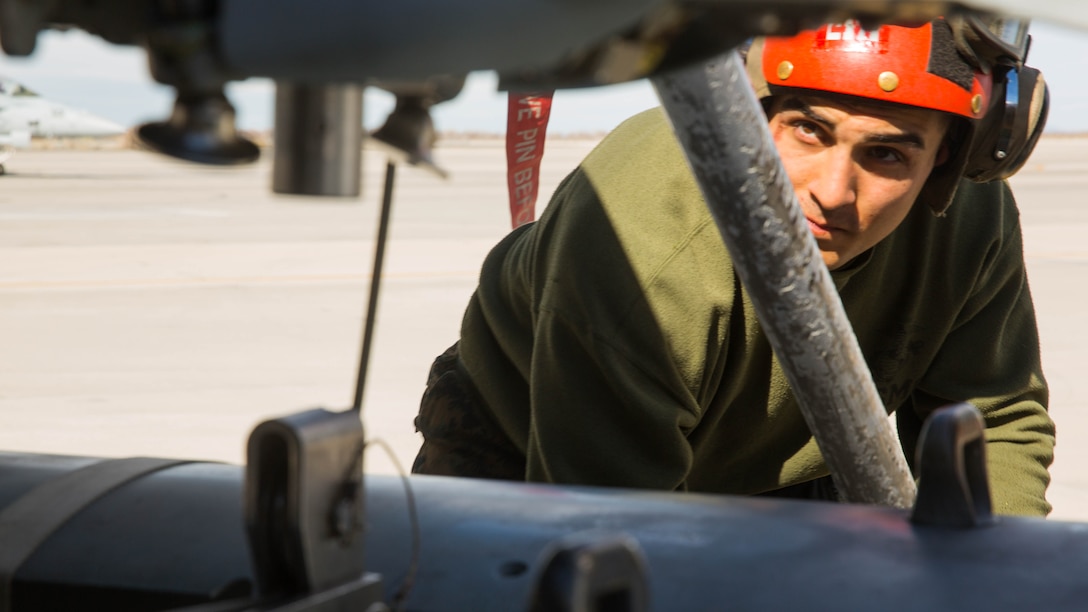 Lance Cpl. Tyler Pratt, an ordnance technician with Marine Fighter Attack Squadron (VMFA) 323 “Death Rattlers,” attaches ordnance to an F/A-18C Hornet at Naval Air Station Fallon, Nev., Feb. 15. The Death Rattlers, one of two Marine Hornet squadrons to deploy aboard Navy aircraft carriers, trained at NAS Fallon to strengthen tactical air integration, fulfill predeployment requirements and build rapport with the Navy squadrons they will deploy with in summer 2017. (U.S. Marine Corps photo by Sgt. Lillian Stephens/Released)