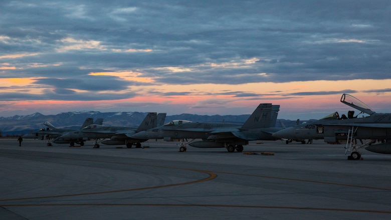 Several F/A-18C Hornets with Marine Fighter Attack Squadron (VMFA) 323 “Death Rattlers” rest on the flight line prior to night operations at Naval Air Station Fallon, Nev., Feb. 15. The Death Rattlers, one of two Marine Hornet squadrons to deploy aboard Navy aircraft carriers, trained at NAS Fallon to strengthen tactical air integration, fulfill predeployment requirements and build rapport with the Navy squadrons they will deploy with in summer 2017. (U.S. Marine Corps photo by Sgt. Lillian Stephens/Released)