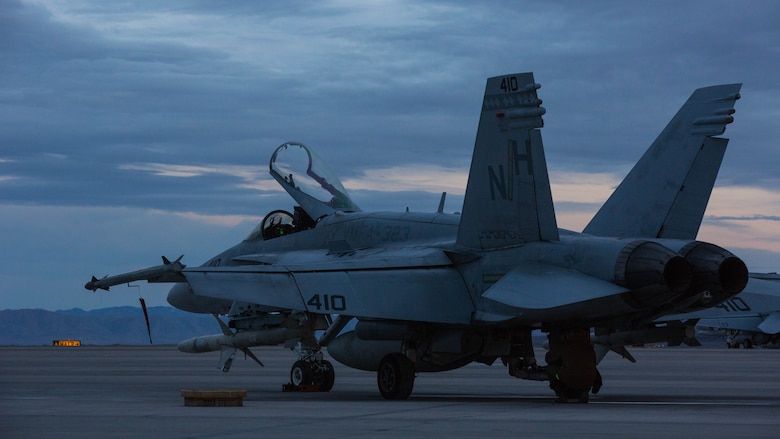 An F/A-18C Hornet with Marine Fighter Attack Squadron (VMFA) 323 “Death Rattlers” rests on the flight line prior to beginning night operations at Naval Air Station Fallon, Nev., Feb. 15. The Death Rattlers, one of two Marine Hornet squadrons to deploy aboard Navy aircraft carriers, trained at NAS Fallon to strengthen tactical air integration, fulfill predeployment requirements and build rapport with the Navy squadrons they will deploy with in summer 2017. (U.S. Marine Corps photo by Sgt. Lillian Stephens/Released)