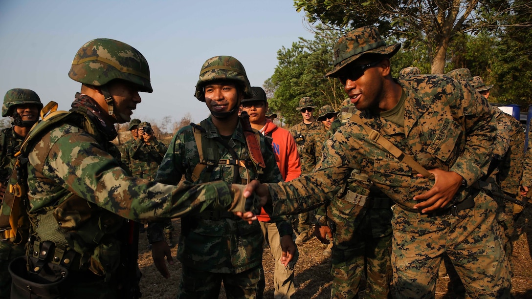 U.S. Marine Cpl. Richard Alston, an infantry squad leader with 1st Platoon, Echo Company, Battalion Landing Team, 2nd Battalion, 5th Marines, 31st Marine Expeditionary Unit, shakes hands with a Royal Thai Marine squad leader Feb. 14, 2017 at Ban Chan Krem, Thailand. Cobra Gold is the largest Theater Security Cooperation exercise in the Indo-Asia-Pacific region and is an integral part of the U.S. commitment to strengthen engagement in the region. During patrols of the Indo-Asia Pacific region, the 31st MEU engages partner nations to sustain theater security and continue integrated bilateral training, furthering cohesion between our militaries. (U.S. Marine Corps photo by Sgt. Tiffany Edwards/Released)