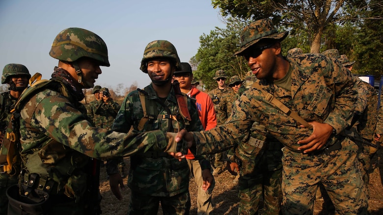 U.S. Marine Cpl. Richard Alston, an infantry squad leader with 1st Platoon, Echo Company, Battalion Landing Team, 2nd Battalion, 5th Marines, 31st Marine Expeditionary Unit, shakes hands with a Royal Thai Marine squad leader Feb. 14, 2017 at Ban Chan Krem, Thailand. Cobra Gold is the largest Theater Security Cooperation exercise in the Indo-Asia-Pacific region and is an integral part of the U.S. commitment to strengthen engagement in the region. During patrols of the Indo-Asia Pacific region, the 31st MEU engages partner nations to sustain theater security and continue integrated bilateral training, furthering cohesion between our militaries. (U.S. Marine Corps photo by Sgt. Tiffany Edwards/Released)