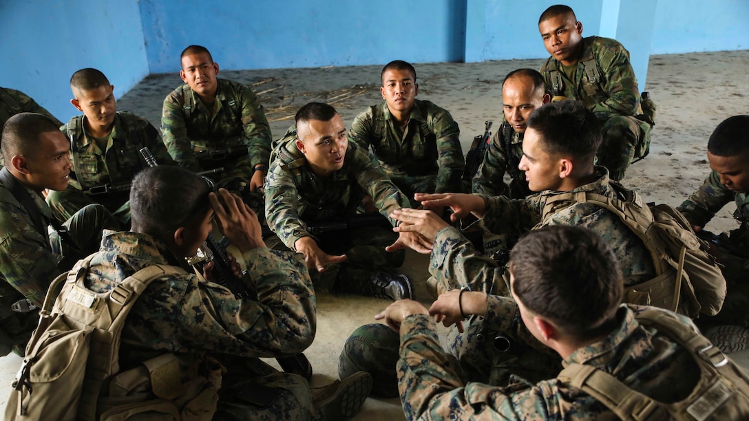 U.S. Marines and Royal Thai Marines discuss training techniques during Exercise Cobra Gold 17 with Royal Thai Marines Feb. 14, 2017 at Ban Chan Krem, Thailand. Cobra Gold is the largest Theater Security Cooperation exercise in the Indo-Asia-Pacific region and is an integral part of the U.S. commitment to strengthen engagement in the region. During patrols of the Indo-Asia Pacific region, the 31st Marine Expeditionary Unit engages partner nations to sustain theater security and continue integrated bilateral training, furthering cohesion between our militaries. (U.S. Marine Corps photo by Sgt. Tiffany Edwards/Released)