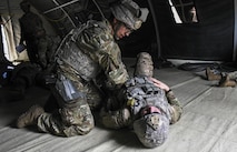 An Airman from the 822d Base Defense Squadron provides care to a simulated casualty after a simulated attack during a Full Mission Profile exercise, Feb. 15, 2017, at Moody Air Force Base, Ga. The 822d BDS is completing training exercises that will gradually increase in difficulty each week to prepare for an upcoming Mission Readiness exercise. The FMP enhanced training by increasing the complications and dangers of scenarios that challenged Airmen on simulated patrols. The exercise also pushed leadership in the Tactical Operation Center to successfully guide the Airmen through the challenges. (U.S. Air Force photo by Airman 1st Class Janiqua P. Robinson)