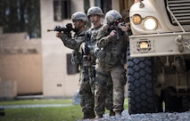 Airmen from the 822d Base Defense Squadron use a Mine Resistant-Ambush Protected Vehicle as cover before while patrolling a village during a Full Mission Profile exercise, Feb. 15, 2017, at Moody Air Force Base, Ga. The 822d BDS is completing training exercises that will gradually increase in difficulty each week to prepare for an upcoming Mission Readiness exercise. The FMP enhanced training by increasing the complications and dangers of scenarios that challenged Airmen on simulated patrols. The exercise also pushed leadership in the Tactical Operation Center to successfully guide the Airmen through the challenges. (U.S. Air Force photo by Airman 1st Class Janiqua P. Robinson)