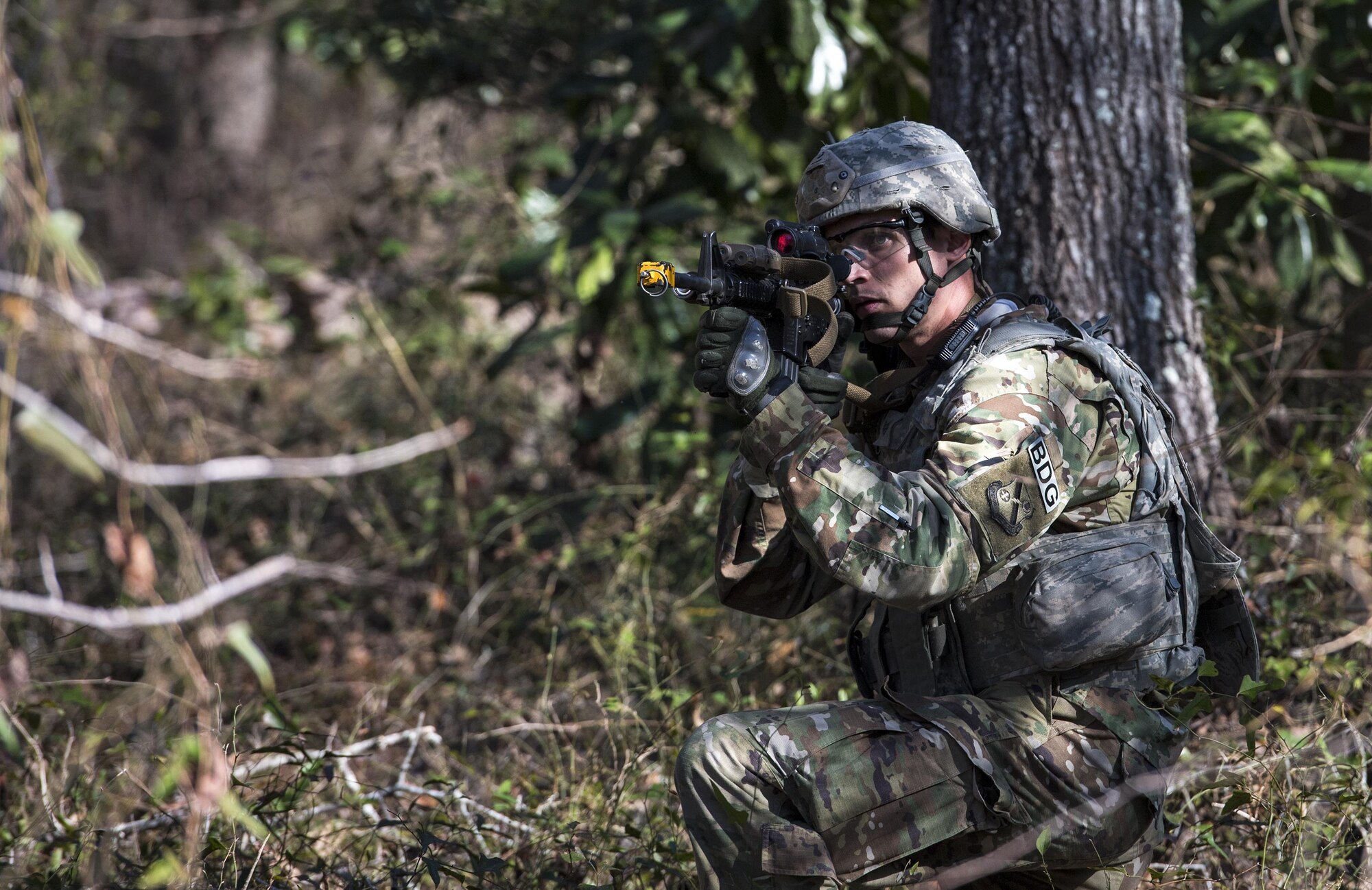 An Airman from the 822d Base Defense Squadron keeps watch for opposing forces during a Full Mission Profile exercise, Feb. 15, 2017, at Moody Air Force Base, Ga. The 822d BDS is completing training exercises that will gradually increase in difficulty each week to prepare for an upcoming Mission Readiness exercise. The FMP enhanced training by increasing the complications and dangers of scenarios that challenged Airmen on simulated patrols. The exercise also pushed leadership in the Tactical Operation Center to successfully guide the Airmen through the challenges. (U.S. Air Force photo by Airman 1st Class Janiqua P. Robinson)