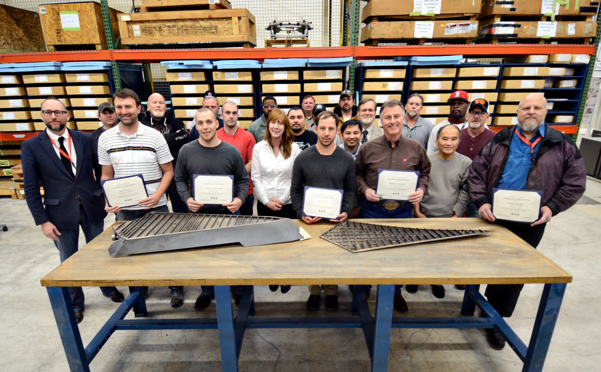 The 76th Propulsion Maintenance Group’s F-22 Aircraft Mounted Nozzle Sidewall back shop team, partnered with Boeing, recently completed the last phase of a depot activation project in support of the F-22 Raptor aircraft by stud welding of the AMNS liner. Four previous phases (blocks 1-4) were completed in a phased manner from 2015 to 2016. At a small Jan. 26 recognition event, Boeing awarded certificates and coins to outstanding performers from PMXG that specifically worked on the last phase of the activation. Holding certificates, from left, are Justin Sneed, PMXG process engineer; William Stambaugh, PMXG machinist; Daniel Dire, PMXG welder; Matthew Beauford, PMXG quality assurance; and Richard Ridley, Boeing F-22 liaison. Chris Brooks, far left, was also recognized as the F-22, C-5 depot activation lead. (Air Force photo by Kelly White)