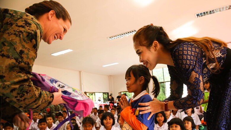 U.S. Marine Corps Col. Maria McMillen, deputy Marine Forces commander, 1st Marine Aircraft Wing, III Marine Expeditionary Force, gives school supplies to a Thai schoolgirl Feb. 15, 2017 at Ban Khok Wat School, Chanthaburi, Thailand. Thai, U.S. and partner nation service members participated in community relation projects at various locations throughout the Royal Kingdom of Thailand during Exercise Cobra Gold 2017. Similar to last year, Cobra Gold 17 emphasizes coordination on civic action, such as humanitarian assistance and disaster relief, seeking to expand regional cooperation and collaboration in these vital areas. (U.S. Marine Corps photo by Sgt. Tiffany Edwards/Released)