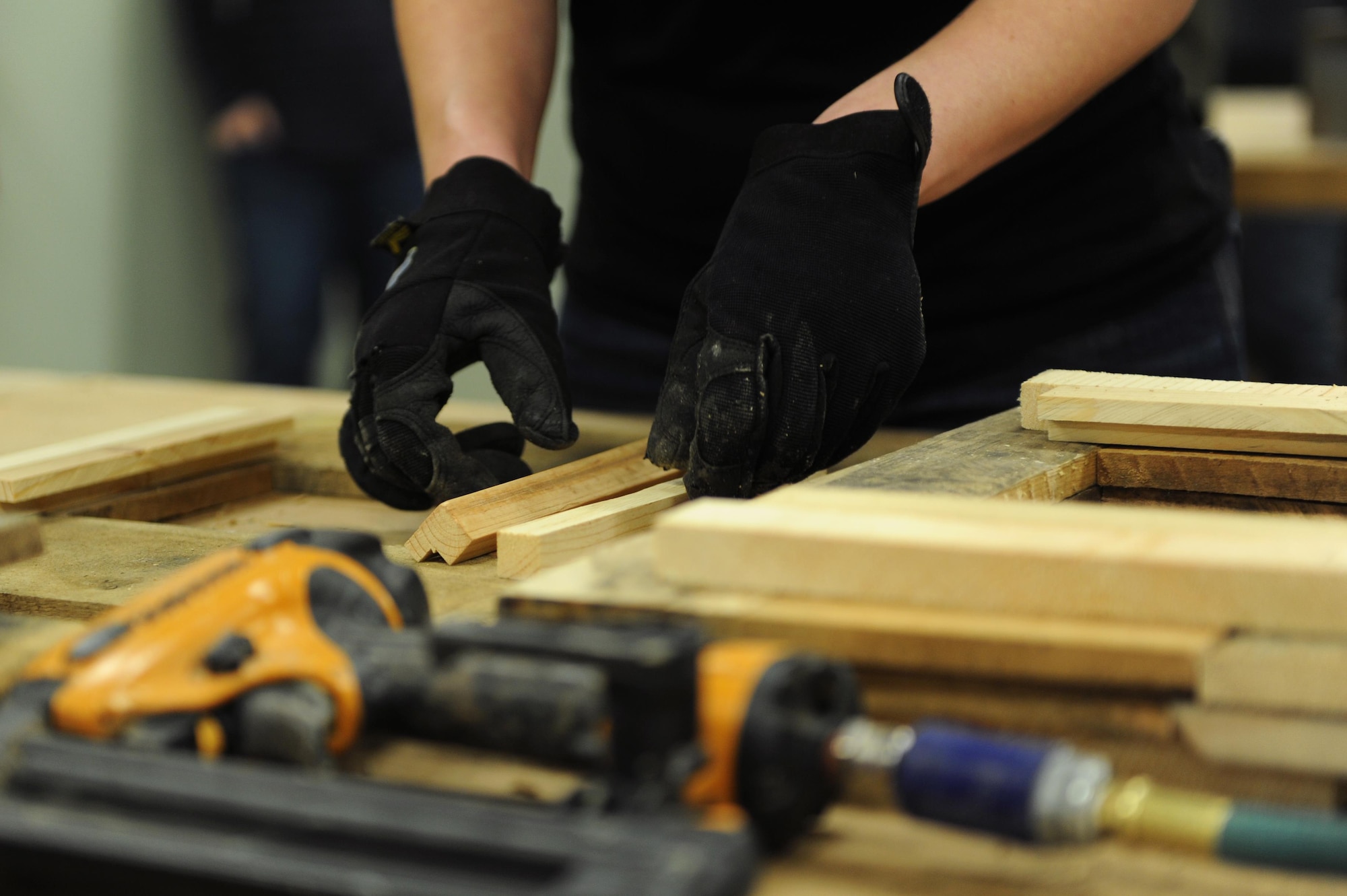 A service member measures wood for a picture frame before nailing the pieces together during a class Feb. 15, 2017, at the 19th Force Support Squadron Skills and Development Center Wood Frame Shop on Little Rock Air Force Base, Ark. Base personnel and service members created three picture frames during an instructional workshop. (U.S. Air Force photo by Airman 1st Class Grace Nichols