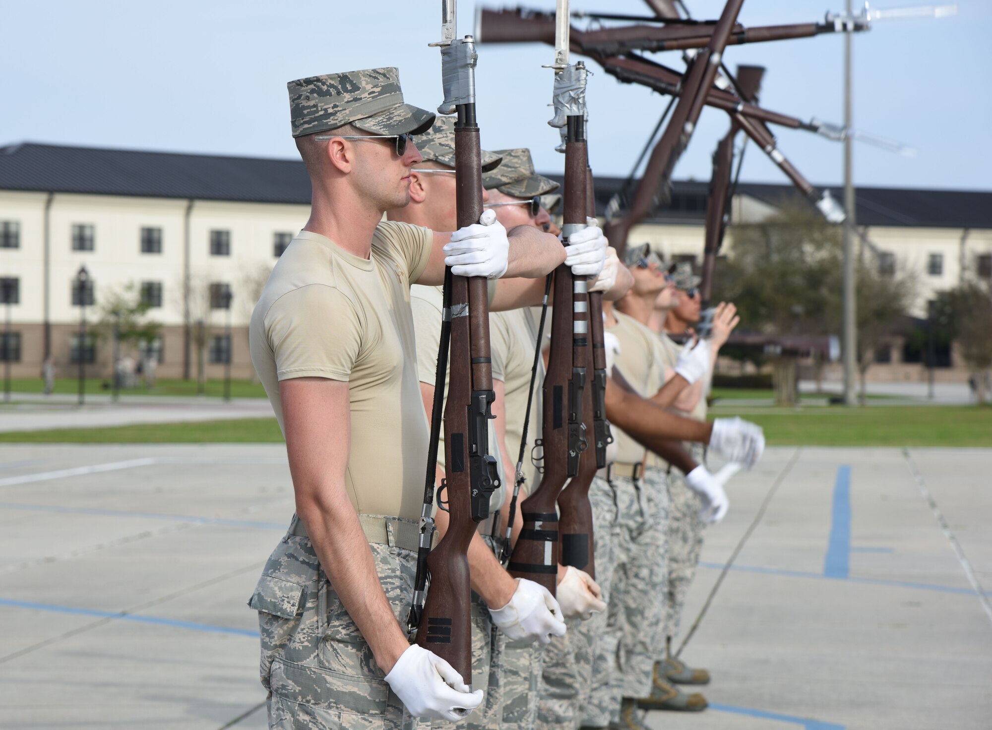 Airmen from the U.S. Air Force Honor Guard Drill Team practice a new routine on the Levitow Training Support Facility drill pad Feb. 26, 2016, on Keesler Air Force Base, Miss. The team comes to Keesler every year for five weeks to develop a new routine, which is then revealed during an 81st Training Group drill down competition. The team preforms the routine used throughout the year. (U.S. Air Force photo by Kemberly Groue)