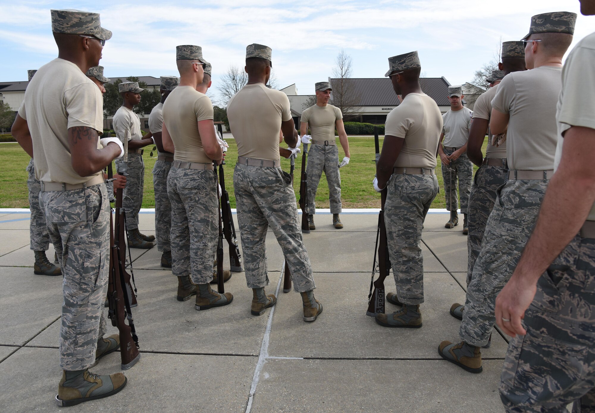 Senior Airman Angelo Hightower, U.S. Air Force Honor Guard Drill Team lead trainer, provides instruction during the practice of a new routine on the Levitow Training Support Facility drill pad Feb. 14, 2017, on Keesler Air Force Base, Miss. The team comes to Keesler every year for five weeks to develop a new routine, which is then revealed during an 81st Training Group drill down competition. The team preforms the routine used throughout the year. (U.S. Air Force photo by Kemberly Groue)