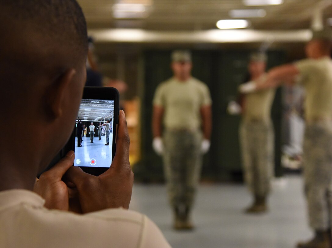 Airmen from the U.S. Air Force Honor Guard Drill Team practices a new routine at the Roberts Consolidated Aircraft Maintenance Facility Feb. 26, 2016, on Keesler Air Force Base, Miss. The team comes to Keesler every year for five weeks to develop a new routine, which is then revealed during an 81st Training Group drill down competition. The team preforms the routine used throughout the year. (U.S. Air Force photo by Kemberly Groue)
