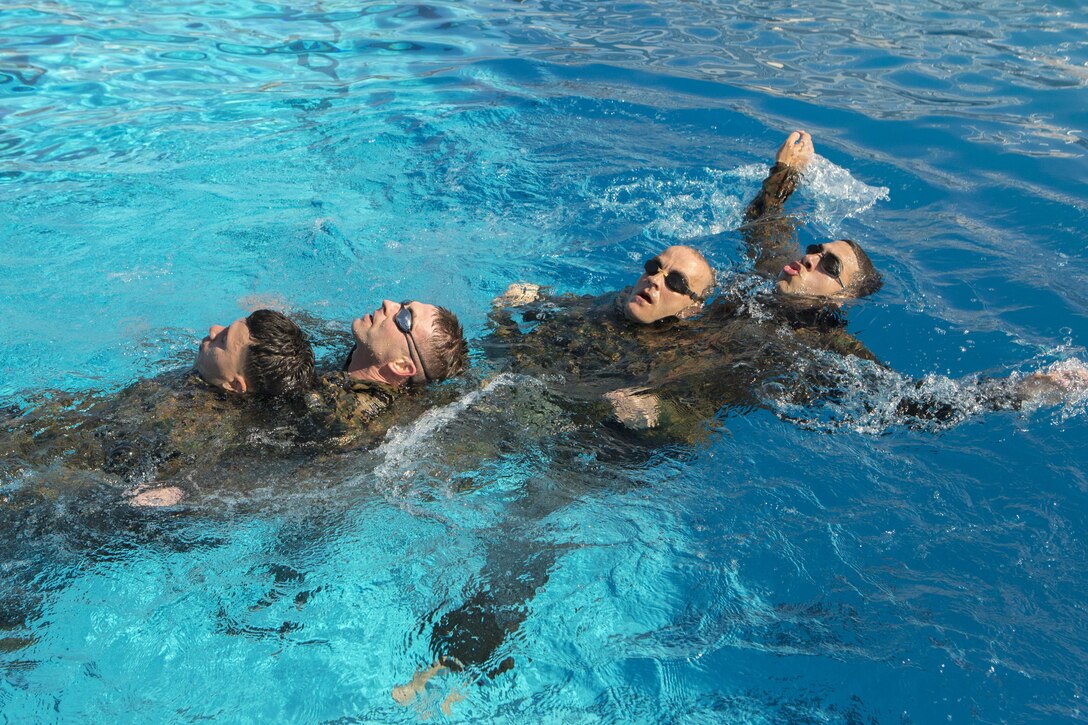 Marines with Headquarters and Headquarters Squadron swim in a “dragon boat” formation at the combat training tank during the Grizzly Challenge at Marine Corps Air Station Miramar, Calif., Feb. 14. The challenge is held quarterly to bring the Marines in the unit together for team building. (U.S. Marine Corps photo by Lance Cpl. Liah Kitchen/Released)