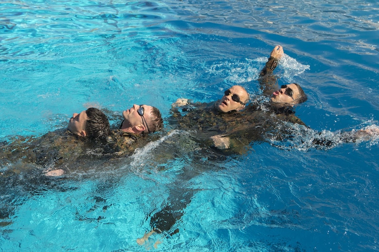 Marines with Headquarters and Headquarters Squadron swim in a “dragon boat” formation at the combat training tank during the Grizzly Challenge at Marine Corps Air Station Miramar, Calif., Feb. 14. The challenge is held quarterly to bring the Marines in the unit together for team building. (U.S. Marine Corps photo by Lance Cpl. Liah Kitchen/Released)