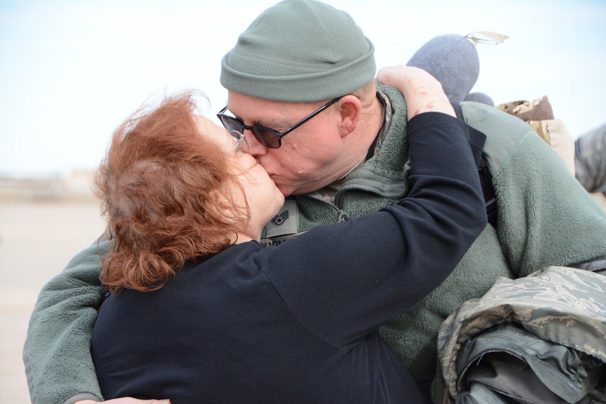 Staff Sgt. Kevin Thomson, a crew chief with the 507th Aircraft Maintenance Squadron, kisses his wife Nancy following a deployment Feb. 17, 2017, at Tinker Air Force Base, Okla. More than 90 Reservists deployed in December 2016 in support of air operations at Incirlik Air Base, Turkey, against the Islamic State group. (U.S. Air Force photo/Tech. Sgt. Lauren Gleason)