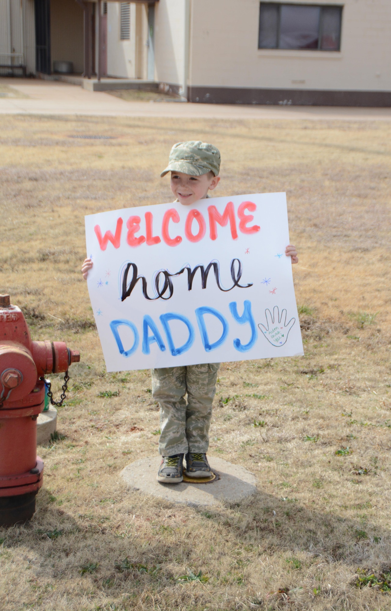 Aiden Teague holds a sign while waiting for his father, Senior Airman Kevin Teague of the 507th Aircraft Maintenance Squadron, to come from a deployment Feb. 19, 2017, at Tinker Air Force Base, Okla. More than 90 Reservists deployed in December 2016 in support of air operations at Incirlik Air Base, Turkey, against the Islamic State group. (U.S. Air Force photo/Tech. Sgt. Lauren Gleason)