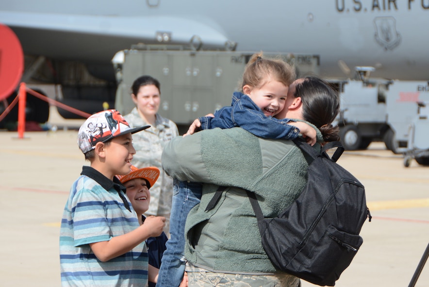 Staff Sgt. Brittany Webb of the 465th Air Refueling Squadron hugs her daughter, Malina, as her sons, Isaiah and Gaberiel, look on following a deployment Feb. 19, 2017, at Tinker Air Force Base, Okla. More than 90 Reservists deployed in December 2016 in support of air operations at Incirlik Air Base, Turkey, against the Islamic State group. (U.S. Air Force photo/Tech. Sgt. Lauren Gleason)