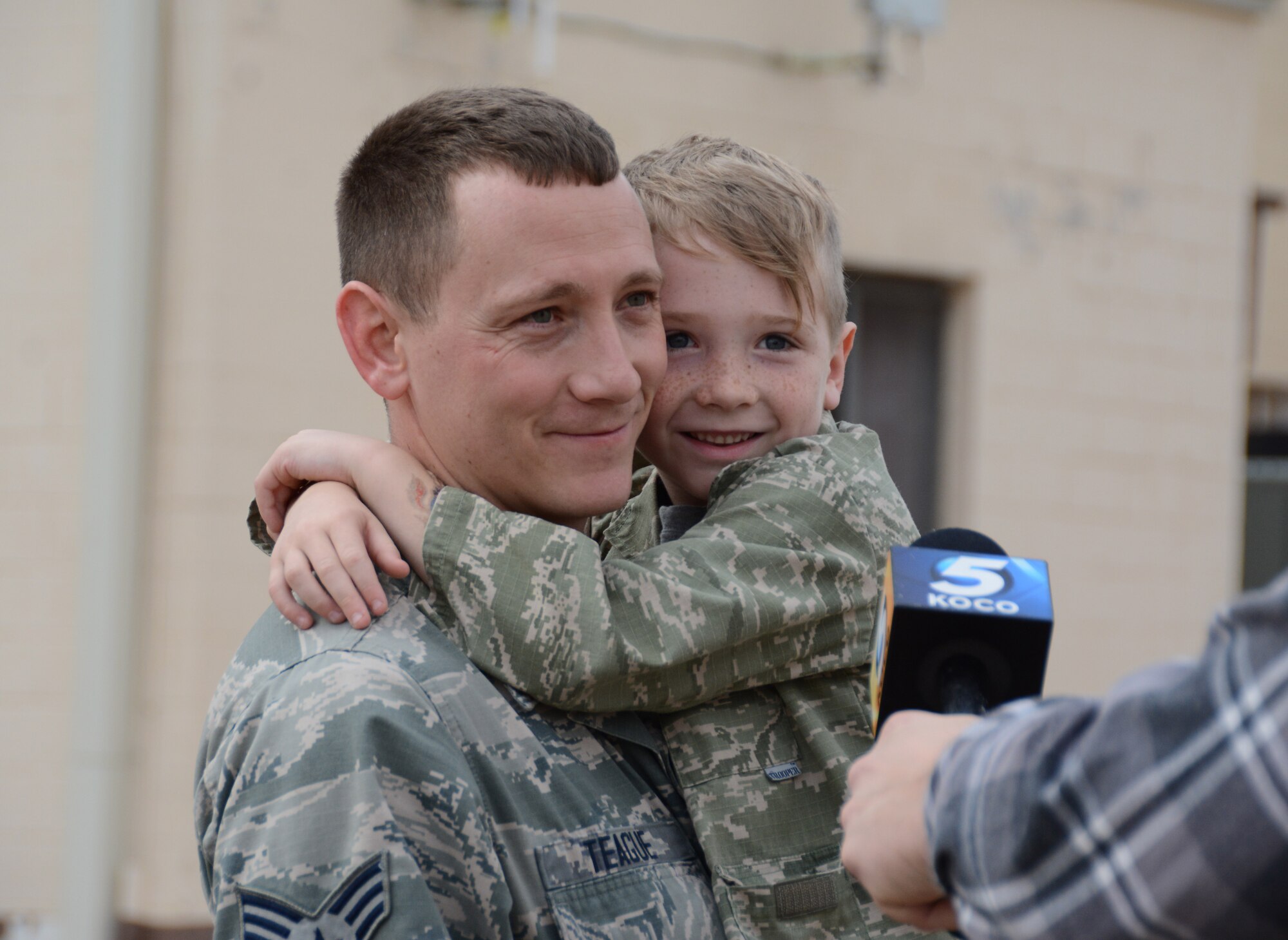 Senior Airman Kevin Teague of the 507th Aircraft Maintenance Squadron holds his son, Aiden, while being interviewed by local media following a deployment Feb. 19, 2017, at Tinker Air Force Base, Okla. More than 90 Reservists deployed in December 2016 in support of air operations at Incirlik Air Base, Turkey, against the Islamic State group. (U.S. Air Force photo/Tech. Sgt. Lauren Gleason)