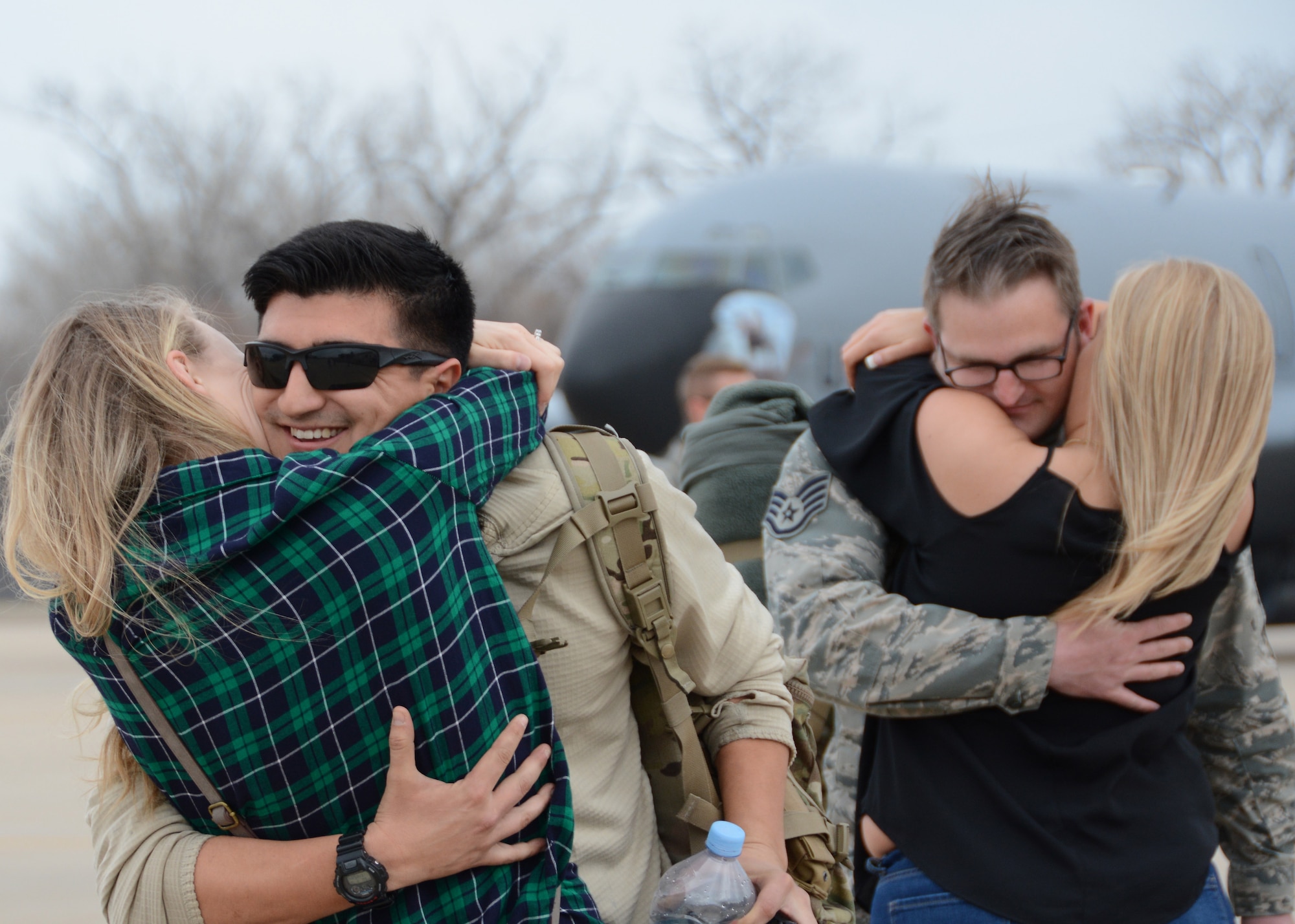 Staff Sgt. Adrian Condit of the 507th Aircraft Maintenance Squadron and Staff Sgt. Mykal Short of the 507th Maintenance Squadron embrace their family members following a deployment Feb. 19, 2017, at Tinker Air Force Base, Okla. More than 90 Reservists deployed in December 2016 in support of air operations at Incirlik Air Base, Turkey, against the Islamic State group. (U.S. Air Force photo/Tech. Sgt. Lauren Gleason)