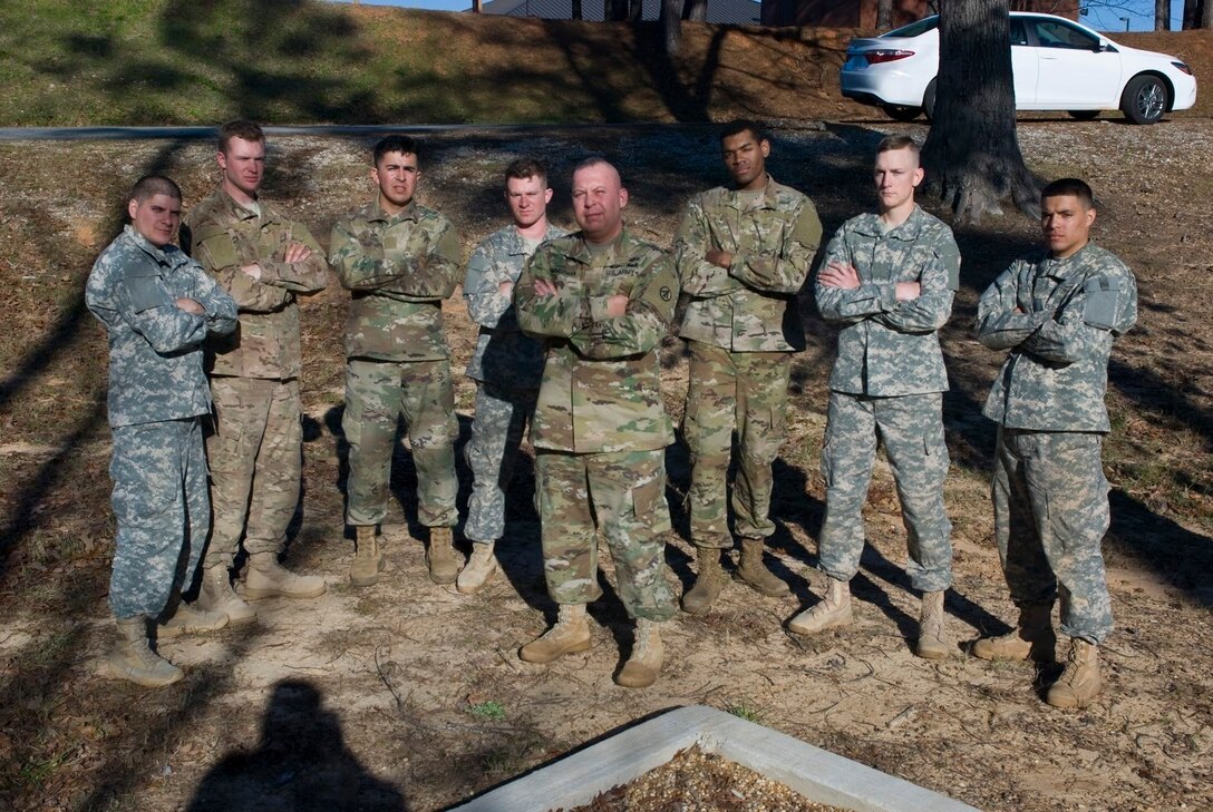 Competitors in the Deployment Support Command’s 2017 Best Warrior Competition held at Fort Benning, Georgia huddle around Command Sgt. Maj. John K. Zimmerman after a long day navigating an obstacle course. Soldiers are selected to represent their home unit in this annual competition. The winner will move on to compete at the 377th Sustainment Support Command’s competition and those winners will compete in the US Army Reserve competition. From there winners go to the All Army competition. From left: Sgt. Kevin Santiago a native of Porto Rico with the 757th Expeditionary Rail Center based in St. Louis, Missouri; Sgt. Brian Sonntag form Sonoma, California with the 1397th Deployment and Distribution Support Battalion, Mare Island in Vallejo, California; Private 1st Class Marco Mata with the 639th Transportation Detachment/1397th Deployment and Support Battalion, Mare Island in Vallejo, California; Spec. John Moore of Corpus Christi, Texas with the 370th Transportation Detachment out of  Sinton, Texas; Spec. Joshua Thomas from Chicago, Illinois with the 757th Expeditionary Rail Center at Fort Sheridan, Illinois; Spec. Christopher Childress from Gulf Shores, Alabama with the 1184th Deployment and Distribution Support Battalion, Mobile, Alabama; Private 1st Class David Ortiz from Brooklyn, New York of the 652nd Transportation Detachment out of Fort Totten, New York; and center, Command Sgt. Maj. John K. Zimmerman of the Deployment Support Command based in Birmingham, Alabama. 