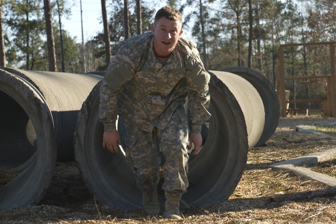 Spc. John Moore of Corpus Christi, Texas with the 370th Transportation Detachment out of Sinton, Texas exits the tunnel crawl obstacle at Fort Benning, Georgia. The obstacle course is just one of the events Soldiers competed in during the Deployment Support Command’s 2017 Best Warrior Competition. The annual competition pits Soldier against Soldier to earn the privilege of representing the Deployment Support Command at the next level of competition and eventually in the All Army Best Warrior Competition. 