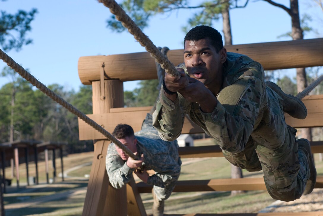 Spc. Joshua Thomas from Chicago, Illinois with the 757th Expeditionary Rail Center at Fort Sheridan, Illinois in front and Spec. John Moore of Corpus Christi, Texas with the 370th Transportation Detachment out of Sinton, Texas pull themselves along the rope obstacle at the Army National Guard Warrior Training Center at Fort Benning, Georgia during the Deployment Support Command’s 2017 Best Warrior Competition. Eight soldiers are competing to represent the DSC at the 377th Theater Support Command's Best Warrior Competition beginning April 9 at Joint Base McGuire Dix Lakehurst, New Jersey.  