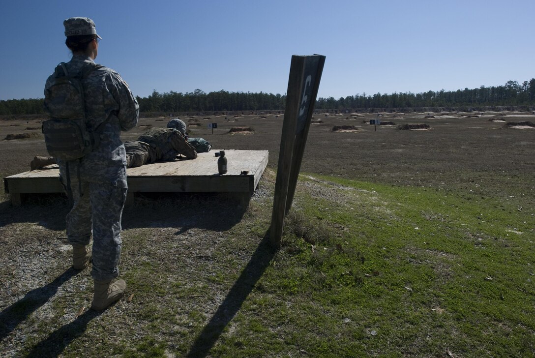 Sgt. Brian Sonntag fires his weapon while Staff Sgt. Yolanda Gonzalez looks on during the Deployment Support Command’s Best Warrior Competition at Fort Benning, Georgia. Both soldiers are with the 1397th Deployment and Distribution Support Battalion, Mare Island in Vallejo, California. Weapons qualification tests Soldier’s accuracy on targets up to 300 meters away. The winners of this competition will go on to compete in the 377th Theater Support Command's Best Warrior Competition beginning April 9 at Joint Base McGuire Dix Lakehurst, New Jersey. 