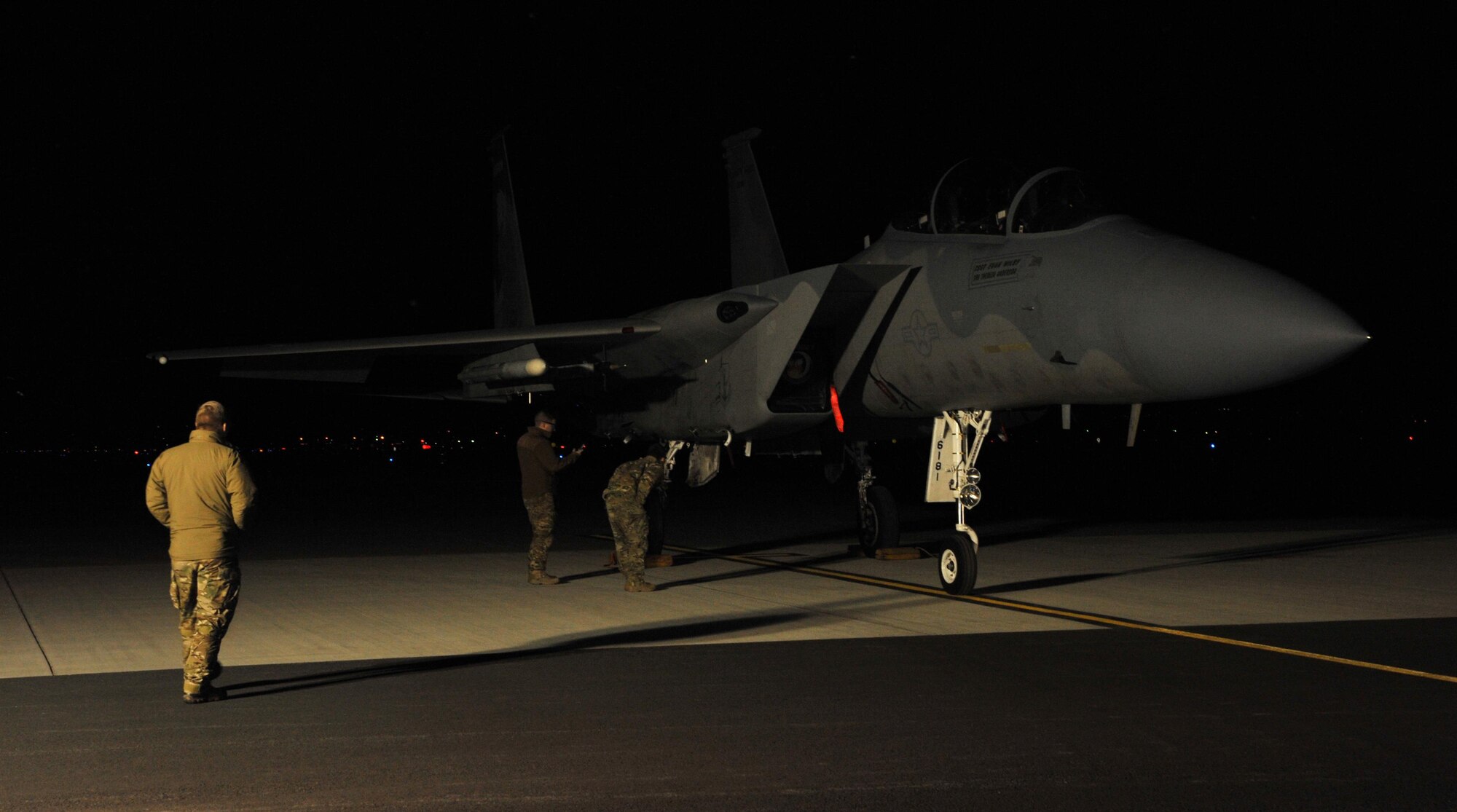 A team of 9th Civil Engineer Squadron explosive ordnance disposal technicians inspects a hung flare on an F-15 Eagle Feb. 6, 2017 at Kingsley Field, Oregon. The Beale EOD unit handles any explosive hazards Kingsley may have. (U.S. Air Force photo/Airman Tristan D. Viglianco)