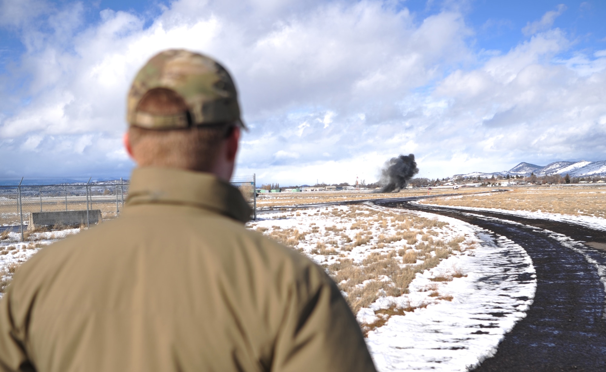 Airman 1st Class Andrew Boyce, 9th Civil Engineer Squadron explosive ordnance disposal technician, observes a flare being detonated via controlled explosion Feb. 7, 2017 at Kingsley Field, Oregon. EOD detonated the flare in an isolated location after all safety precautions were met. (U.S. Air Force photo/Airman Tristan D. Viglianco)