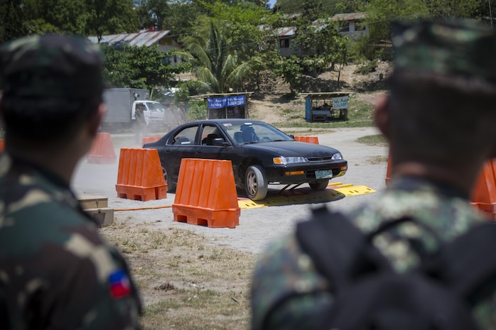 Philippine Armed Forces service members observe a demonstration of the pre-emplaced electric vehicle stopper, "The Vehicle Tazer" system while partaking in a joint non-lethal weapons demonstration and assessment during Balikatan 2014 at Crow Valley, Capas Tarlac, Republic of the Philippines, May 8, 2014. Balikatan is an annual bilateral training evolution that helps maintain a high level of interoperability and enhances military-to-military relations and combined combat capabilities. (U.S. Marine Corps photo by Lance Cpl. Allison DeVries/Released)