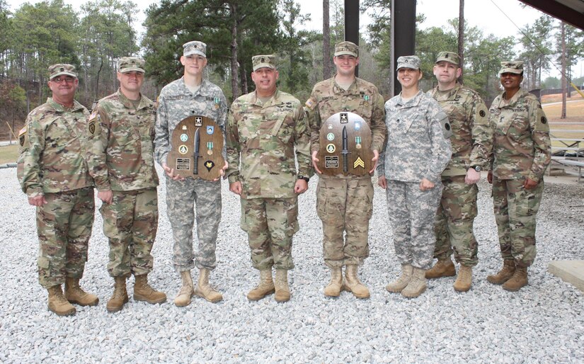 The 2107 Best Warrior completion winners  SPC Christopher Childress (2nd from left) and  SGT Brian Sonntag (3nd from right) show off their Best Warrior trophies with CSM Stevens (left)  CSM Zimmerman (Center), CSM Soto (2nd from right and CSM Anrus-Sam. 
