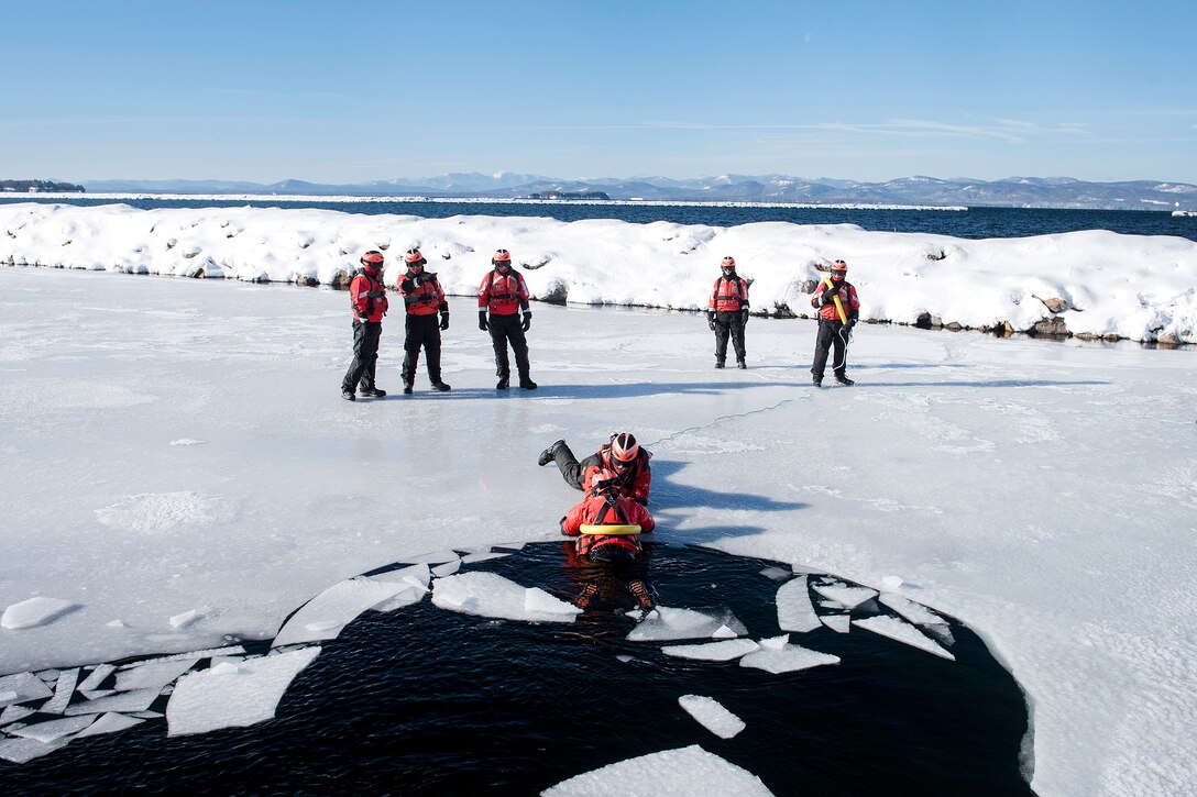 Members of the Coast Guard participate in rescuing simulated cold water victims from Lake Champlain during ice water rescue training at Coast Guard Station Burlington, Vt., Feb. 17, 2017. Air National Guard photo by Tech. Sgt. Sarah Mattison