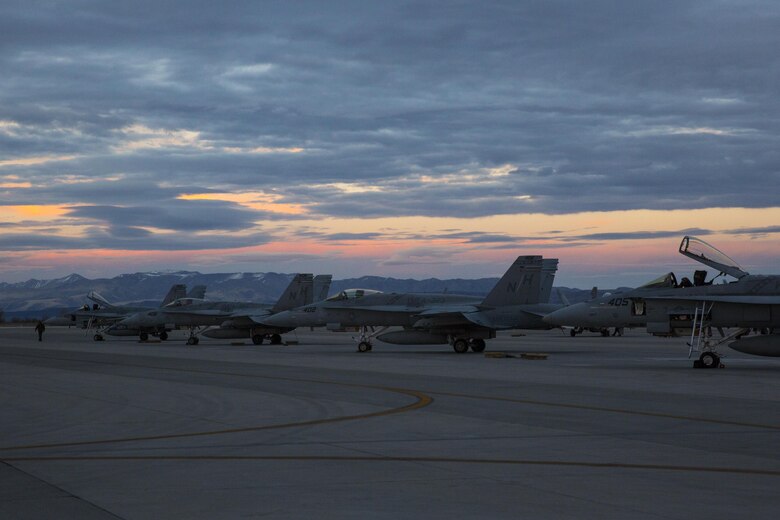 Several F/A-18C Hornets with Marine Fighter Attack Squadron (VMFA) 323 “Death Rattlers” rest on the flight line prior to night operations at Naval Air Station Fallon, Nev., Feb. 15. The Death Rattlers, one of two Marine Hornet squadrons to deploy aboard Navy aircraft carriers, trained at NAS Fallon to strengthen tactical air integration, fulfill predeployment requirements and build rapport with the Navy squadrons they will deploy with in summer 2017. (U.S. Marine Corps photo by Sgt. Lillian Stephens/Released)