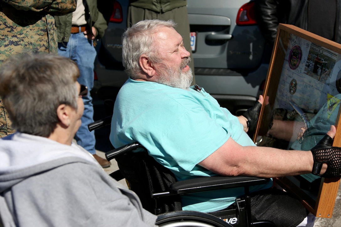 James Tooker, right, admires a shadow box given in honor of his retirement aboard Marine Corps Air Station Cherry Point, N.C., Feb. 10, 2017.  A cookout was held in “Jimmy’s” honor during a retirement ceremony.  A U.S. Army veteran, Tooker formed a lasting bond with many of the Marines who worked in the department. (U.S. Marine Corps photo by Cpl. Jason Jimenez/ Released)