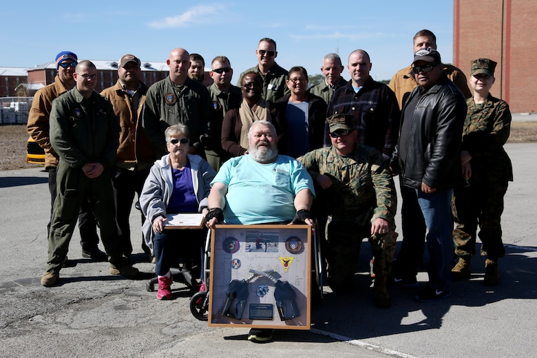 James Tooker, front row and center, retired after 41 years working as a fuel inspector aboard Marine Corps Air Station Cherry Point, N.C., Feb. 10, 2017.  “The Marines call me all the time from all over the place telling me that I’ve touched their lives,” said Tooker.  Station fuels department personnel held a cookout and award ceremony in Tooker’s honor as a farewell. (U.S. Marine Corps photo by Cpl. Jason Jimenez/ Released)