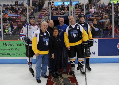 Members of the Charleston Patriots, the Charleston Enforcers and Col. Robert Lyman, center, Joint Base Charleston commander, poses for a photo with the Matuskovic family after dropping the puck during the 3rd Annual Matuskovic Charity Hockey Game at the North Charleston Coliseum & Performing Arts Center, Feb. 18, 2017. The game is played in memory of Joe Matuskovic, Charleston County Sherriff’s deputy and other service members and first responders killed in the line of duty. Members of the Charleston Patriots are from Joint Base Charleston while members of the Charleston Enforcers are from the Charleston County Sheriff’s office and fire department.