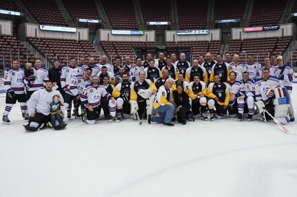 The Charleston Patriots and the Charleston Enforcers pose for a photo after the 3rd Annual Matuskovic Charity Hockey Game at the North Charleston Coliseum & Performing Arts Center, Feb. 18, 2017. The game is played in memory of Joe Matuskovic, Charleston County Sherriff’s deputy, and other service members and first responders killed in the line of duty. Members of the Charleston Patriots are from Joint Base Charleston while members of the Charleston Enforcers are from the Charleston County Sheriff’s office and fire department. The Charleston Enforcers won the game with a final score of 10-2. 