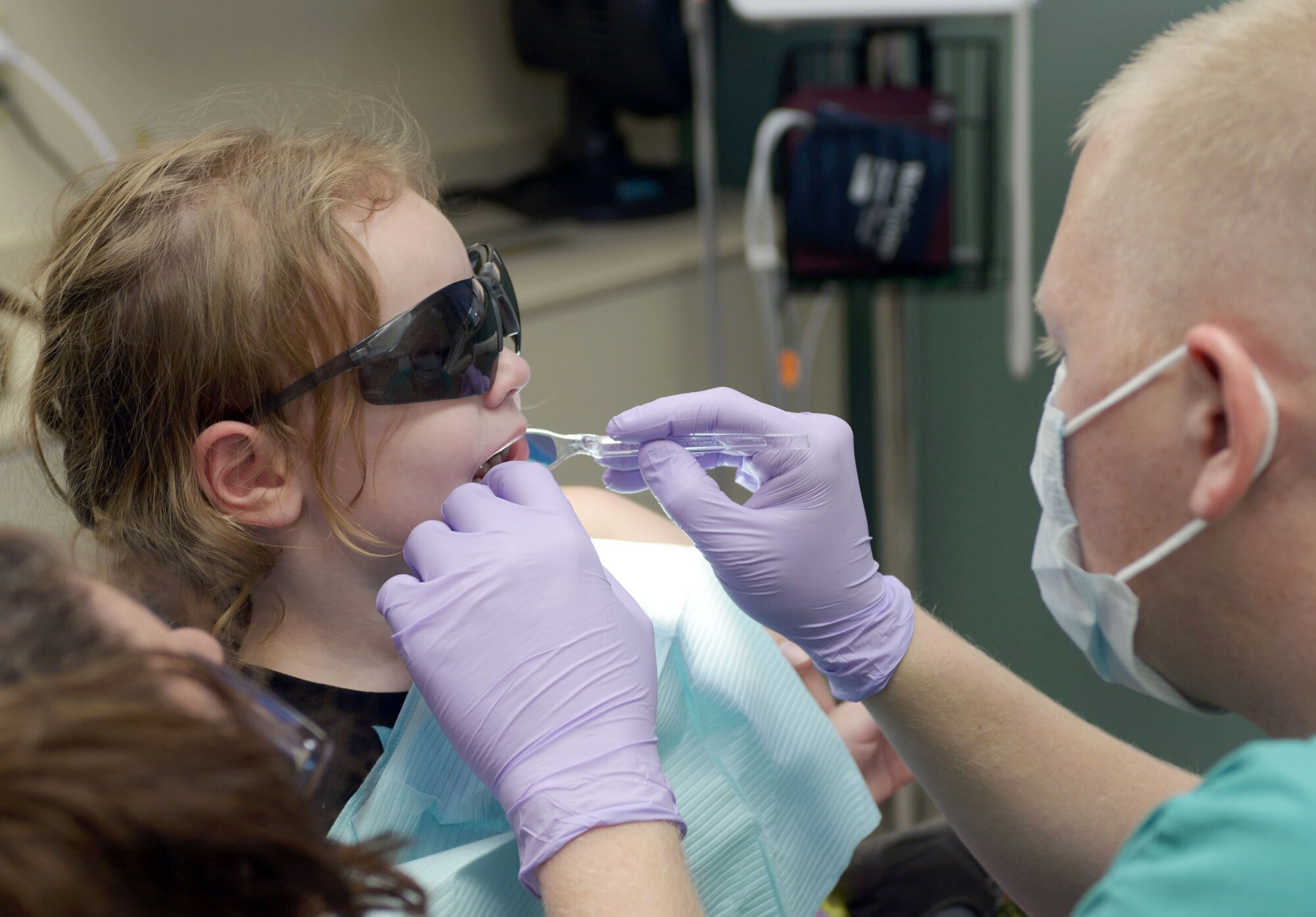 Emily Rusnak, daughter of Cari and Staff Sgt. Michael Rusnak, an engineering journeyman assigned to the 28th Civil Engineer Squadron, receives dental care in the 28th Medical Group dental office at Ellsworth Air Force Base, S.D., Feb. 15, 2017. As part of National “Give Kids a Smile Day” children of base personnel were provided with free dental care and treatment. (U.S. Air Force photo by Airman 1st Class Donald C. Knechtel)