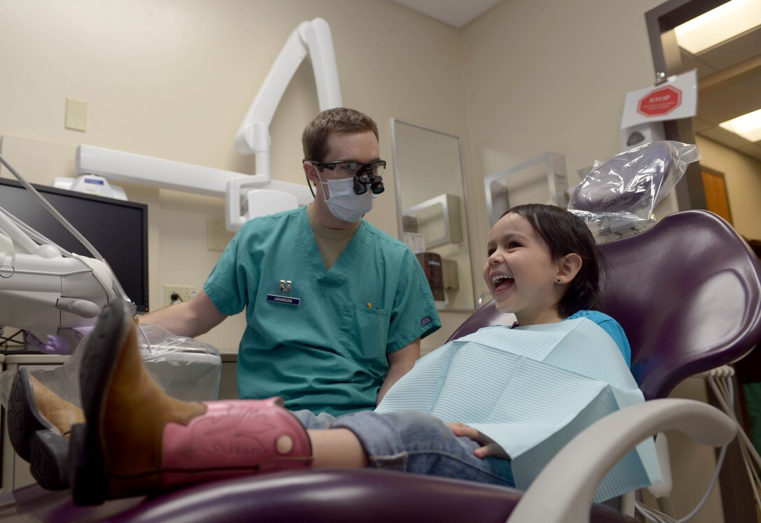 Capt. Ross Johnson, a dentist assigned to the 28th Medical Operations Squadron, prepares to do a checkup on Jaida Schlemmer, daughter of Ruben and Airman 1st Class Verenice Schlemmer, a vehicle operator assigned to the 28th Logistics Readiness Squadron, in the 28th Medical Group dental office at Ellsworth Air Force Base, S.D., Feb. 15, 2017. In lieu of National “Give Kids a Smile Day,” families received free dental health screenings, fluoride, sealants, toothbrushes, toothpaste, and educational materials. (U.S. Air Force photo by Airman 1st Class Donald C. Knechtel)