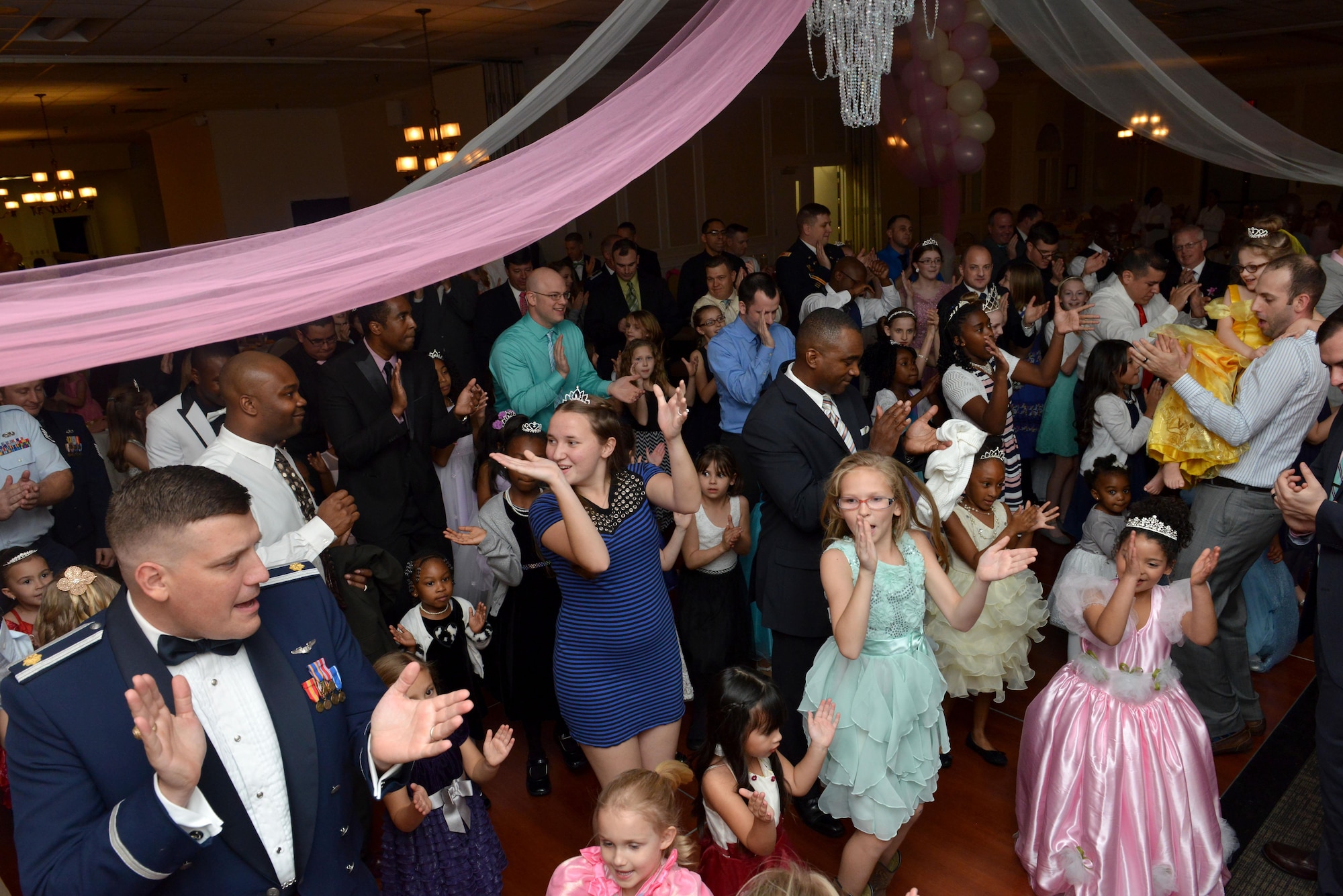 Team Shaw members clap their hands while dancing during a “Royal Affair” father-daughter princess ball at Shaw Air Force Base, S.C., Feb. 18, 2017. More than 100 couples signed up for the dance, which included entertainment, dinner and activities such as musical chairs. (U.S. Air Force photo by Airman 1st Class Destinee Sweeney)